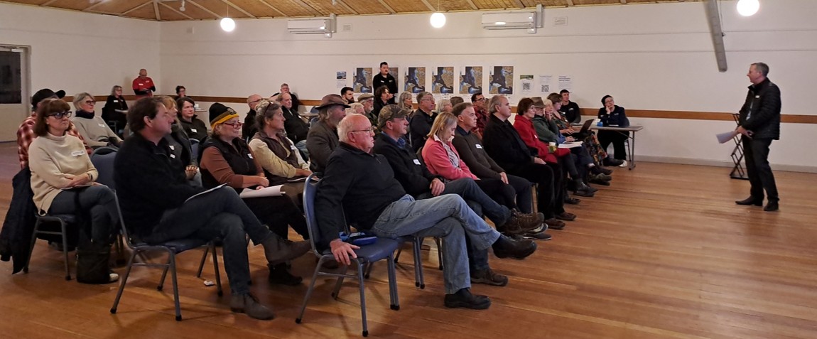 An image taken from the side of a group of people watching a presentation on Newstead Flood Study inside Newstead Community Centre